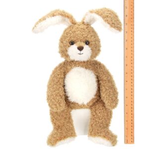 Brown plush bunny toy beside a ruler for size.