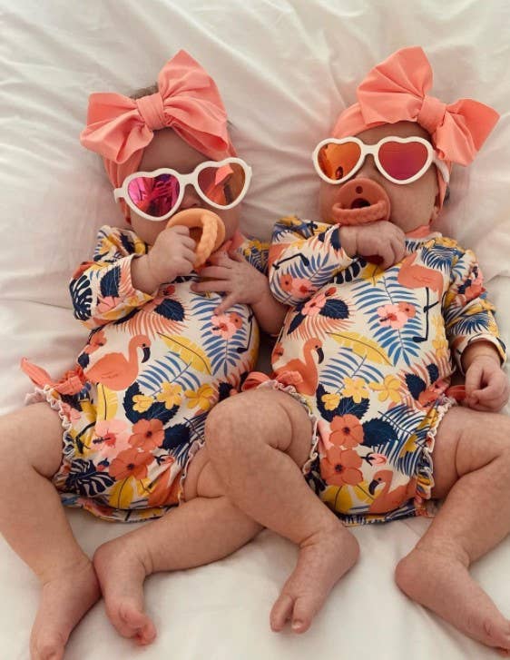 itzy ritzy sweetie soother™ pacifier sets (2 pack): pink bows Twins in tropical outfits with pink bows
