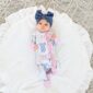 Baby in bow outfit on soft rug