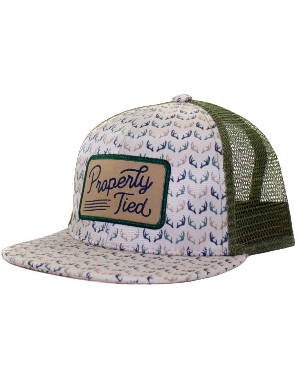 Mesh trucker hat with antler pattern and patch.