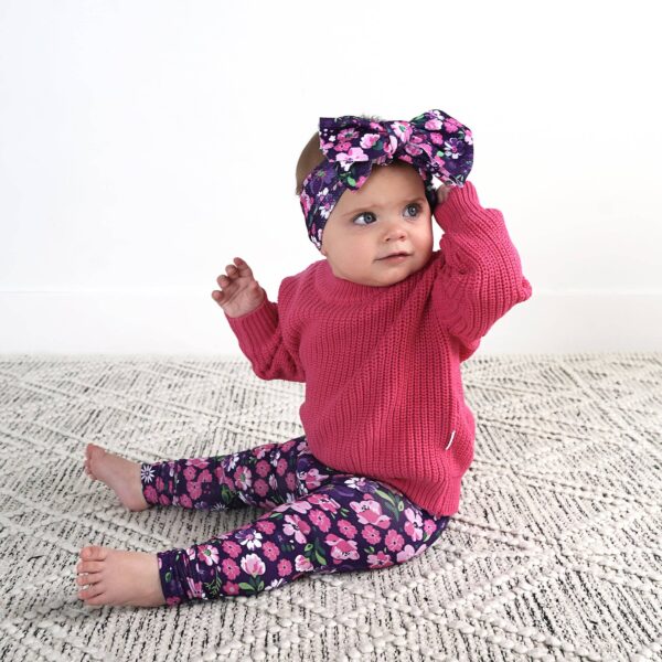 gigi and max mila leggings and sweater set Baby in pink outfit with floral headband sitting.