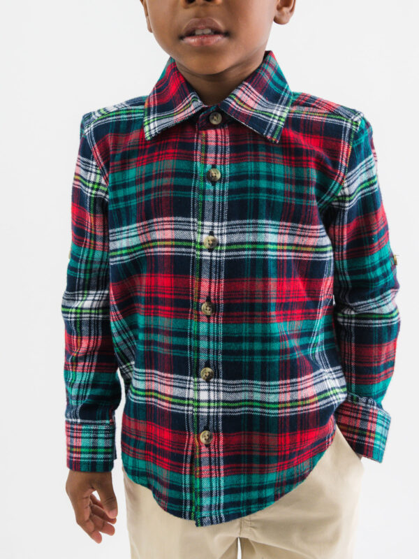 Child wearing plaid shirt, beige pants.