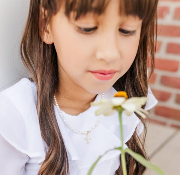 cherished moments girls 14k gold plated first communion kids cross necklace Girl in white dress with a flower.
