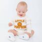 Baby wearing 'Little Pumpkin' outfit, smiling.