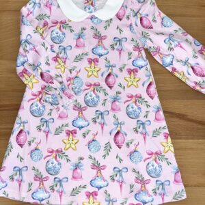 Pink children's dress with Christmas ornament pattern.