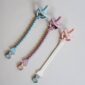 Three colorful silicone pacifiers with clips