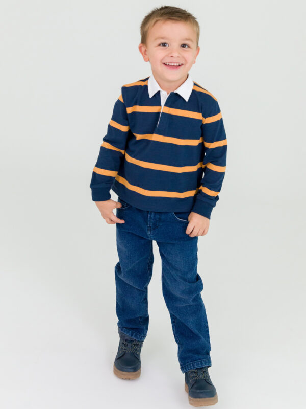 Smiling child in striped shirt and jeans.