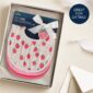 Gift set of strawberry-patterned baby bibs in box.