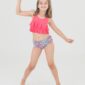 Girl in colorful swimsuit posing happily.