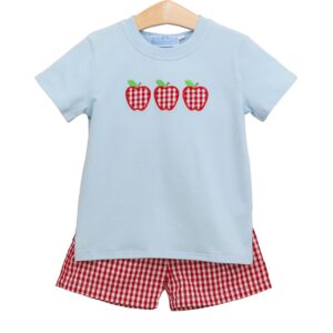 Blue shirt with apple design and plaid shorts.