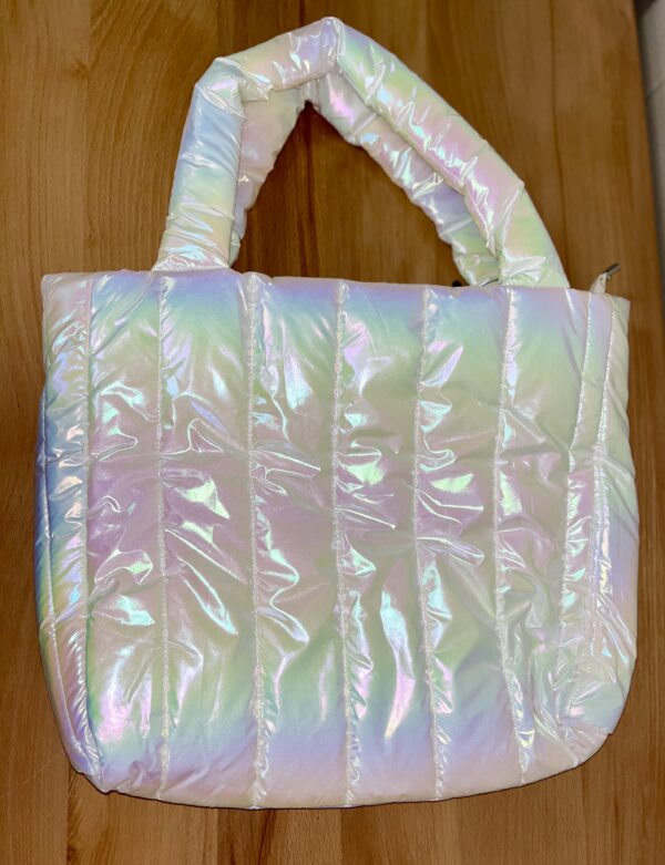 ml kids iridescent white overnight bag Iridescent puffy tote bag on wooden surface.