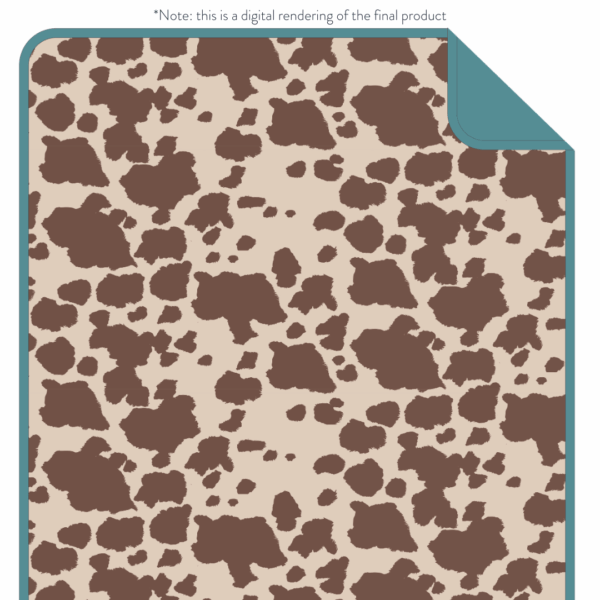 itzy ritzy itzy blanket™: giddy up! Cow print rug with teal border.