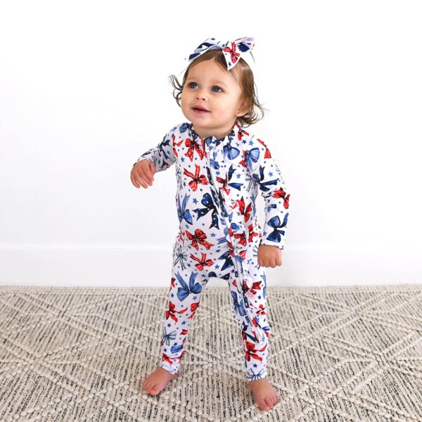 gigi and max eleanor bow clip bow 4th of july hair accessory Baby in butterfly-patterned outfit with matching bow.