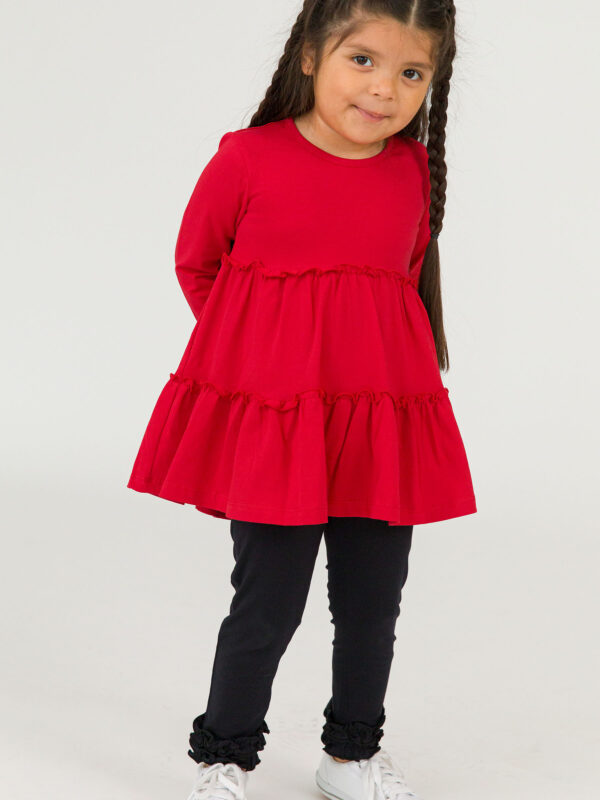 rufflebutts signature ruffle leggings black Child in red dress and black leggings smiling.