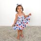 Toddler in floral dress with matching headband.