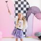 Girl in Halloween costume with wand, colorful backdrop.