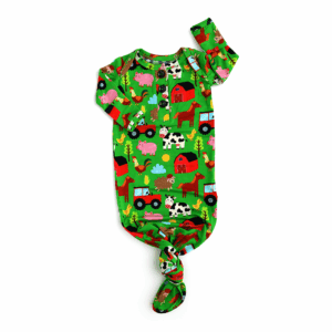 Colorful farm-themed infant sleeper outfit.