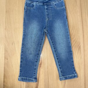 Blue denim jeans on wooden floor