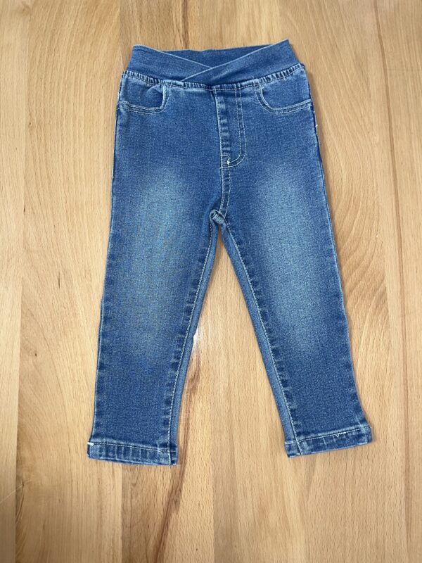Blue denim jeans on wooden floor