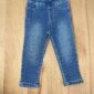 Blue denim jeans on wooden floor