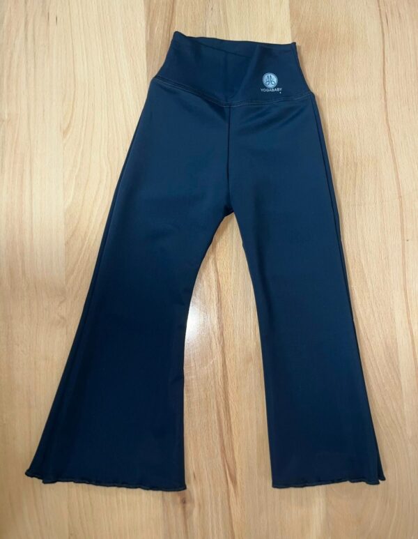 product Black yoga pants on wooden floor.