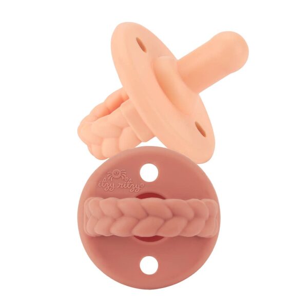 itzy ritzy sweetie soother™ pacifier sets (2 pack): aquamarine + peach bows Peach-colored braided silicone pacifier for babies.