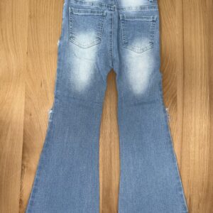 Blue flared jeans on wooden floor