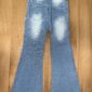 Blue flared jeans on wooden floor