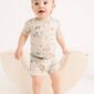 Baby wearing farm-themed pajamas on rocking chair.