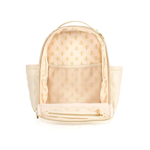 itzy ritzy milk & honey itzy mini plus™ diaper bag backpack Open cream backpack with bee pattern interior.