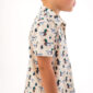 Child wearing duck-patterned shirt, side profile view.