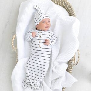 Baby in striped outfit lying in basket