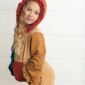Child in colorful hoodie posing indoors