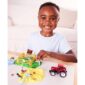 Child playing with toy farm animals and tractor.