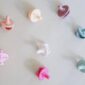 Colorful pacifiers on neutral background