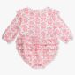 Baby romper with pink pumpkin pattern and ruffles.