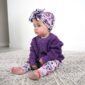 Baby in purple sweater and floral pants
