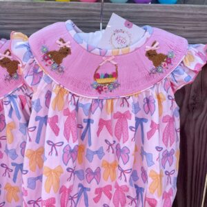 Pink baby dress with bow and rabbit embroidery.
