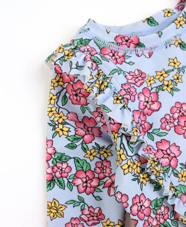 rufflebutts cheerful blossoms princess seam ruffle rash guard 2 piece Floral pattern, blue fabric with pink and yellow flowers.