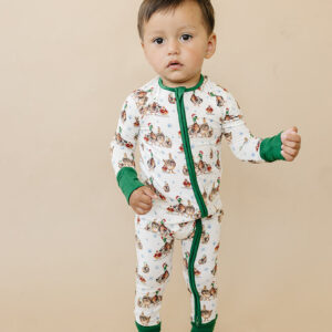 Toddler in duck-themed pajamas standing.