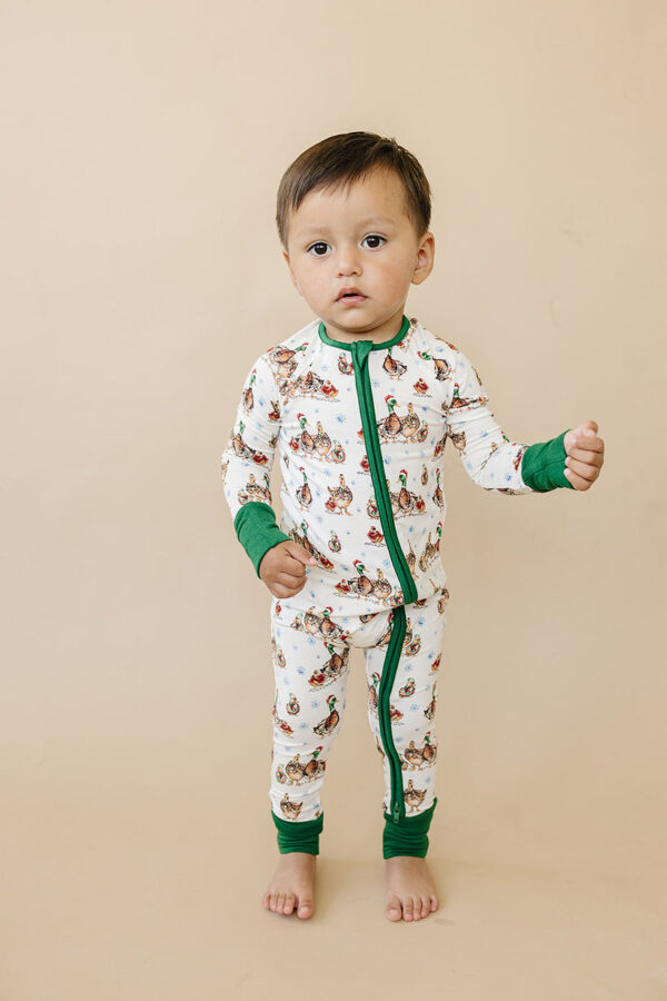 velvet fawn merry mallards bamboo christmas pajamas Toddler in duck-themed pajamas standing.