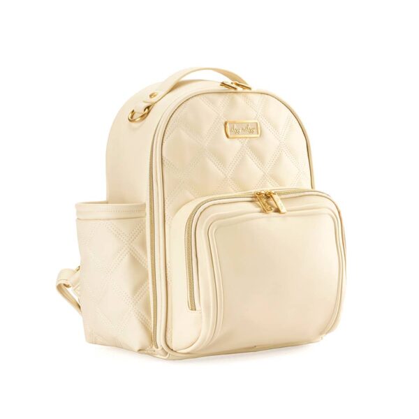 itzy ritzy milk & honey itzy mini plus™ diaper bag backpack Cream-colored quilted backpack with gold zippers