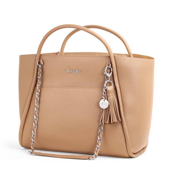 itzy ritzy *new/restocked* chai latte boss tote™ Tan handbag with silver chain and tassel.