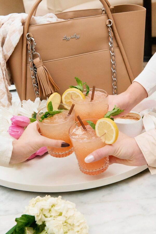 itzy ritzy *new/restocked* chai latte boss tote™ Pink drinks with lemon, mint garnishes.