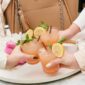 Pink drinks with lemon, mint garnishes.
