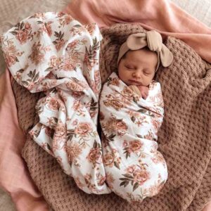 Sleeping baby wrapped in floral blanket