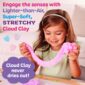 Child playing with stretchy pink cloud clay.