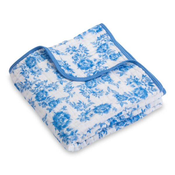 lollybanks a peony for your thoughts baby toddler muslin quilt Blue floral-patterned blanket folded neatly.