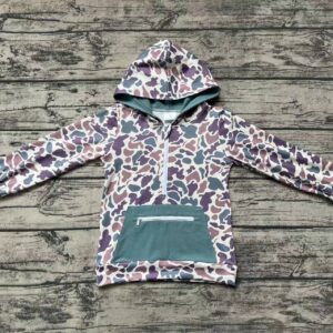 Children's camo hooded jacket on wooden background.