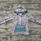 Children's camo hooded jacket on wooden background.
